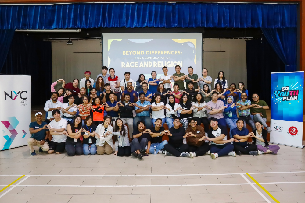 Group photo of diverse people making heart shapes